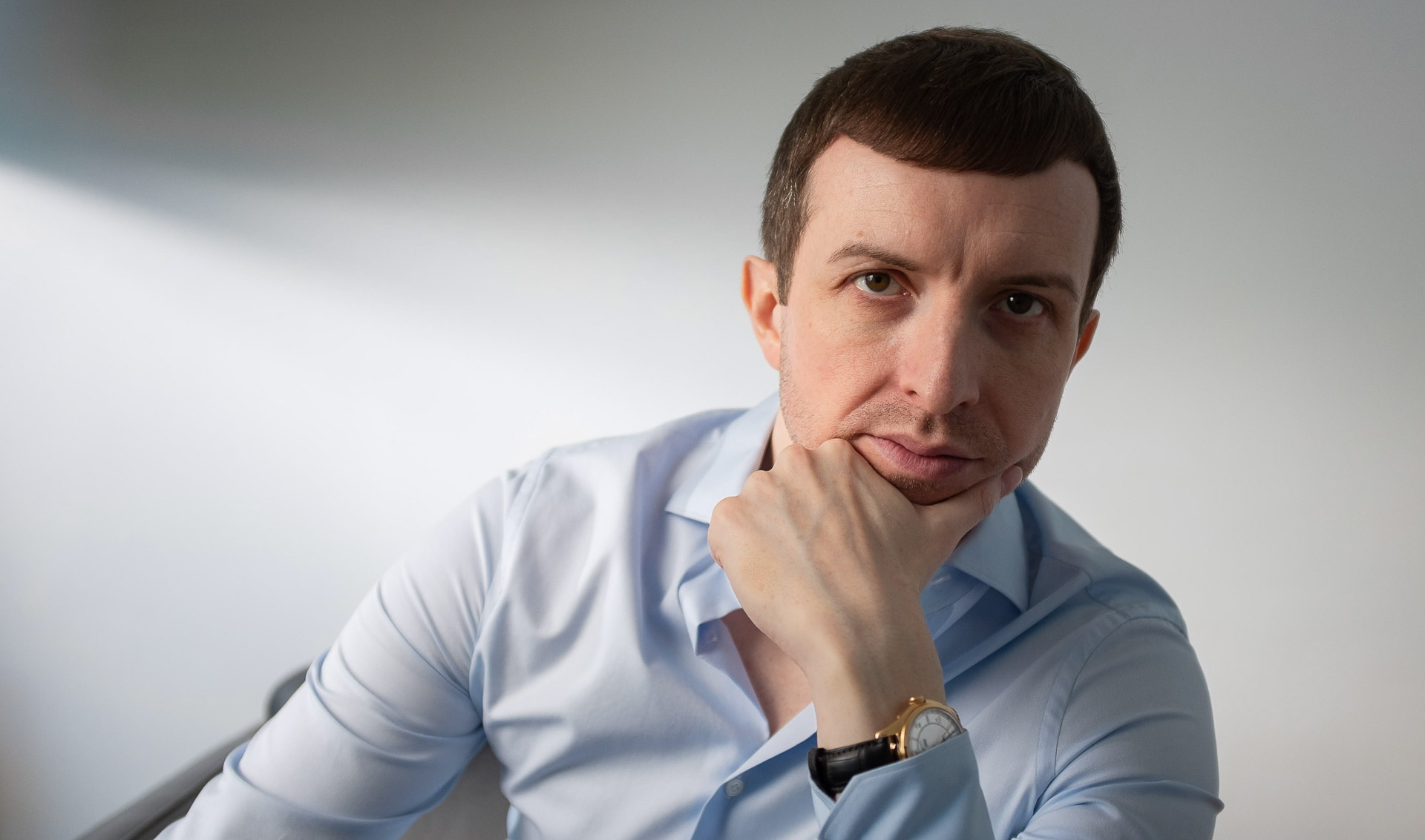 A professional portrait of Michael Serwa, a leading career coach in London, with a serious and focused expression.