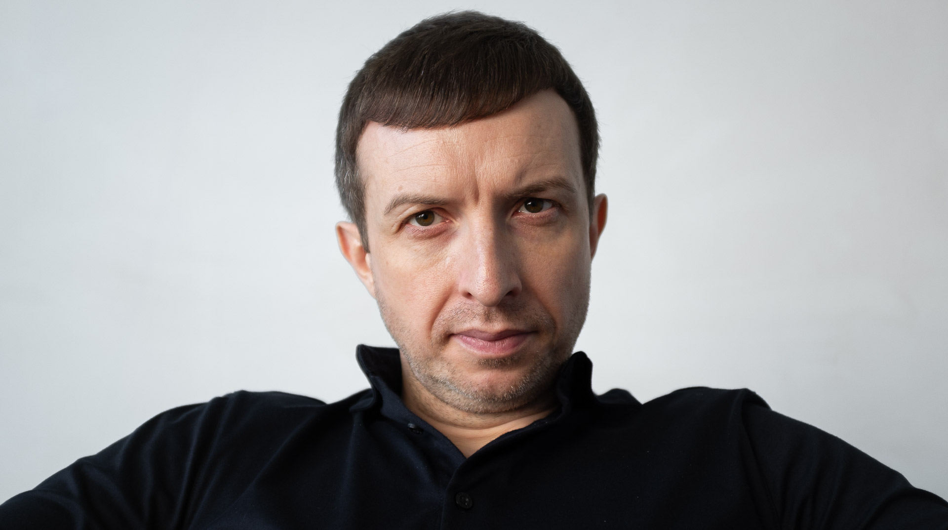 Michael Serwa, a top business coach based in London, looking directly at the camera with a serious, determined expression.