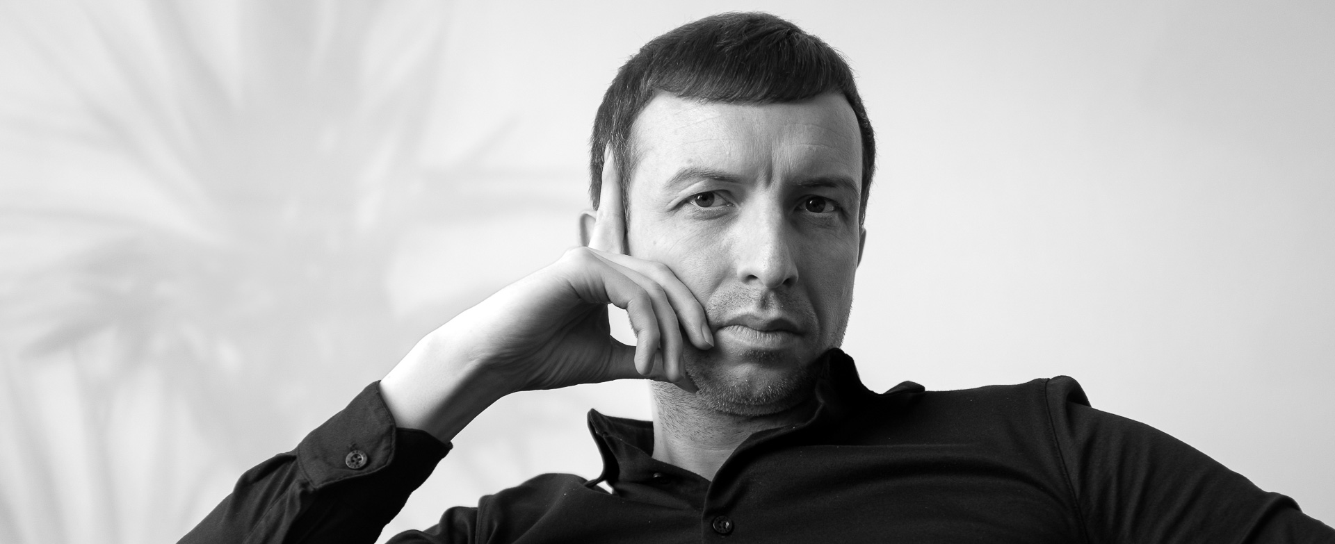 Michael Serwa is photographed in a calm, deep focus pose, representing clarity and presence in leadership.